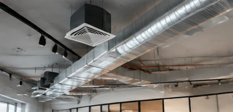 Exposed ceiling with air-conditioning ducts and a cassette unit