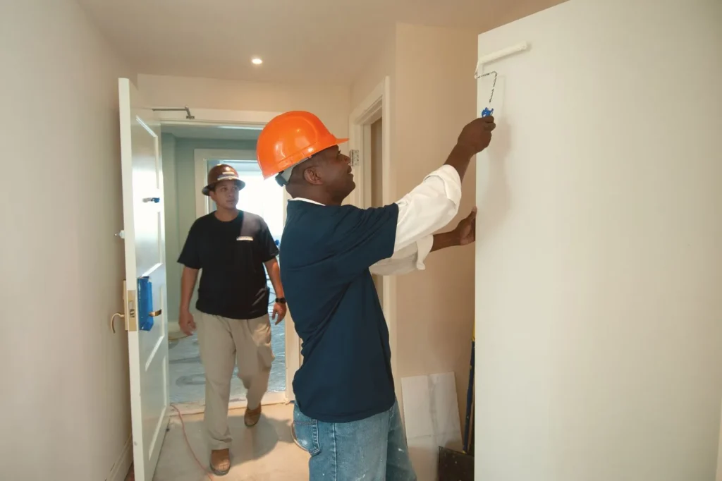 Fit-out workers painting interior walls during an office renovation