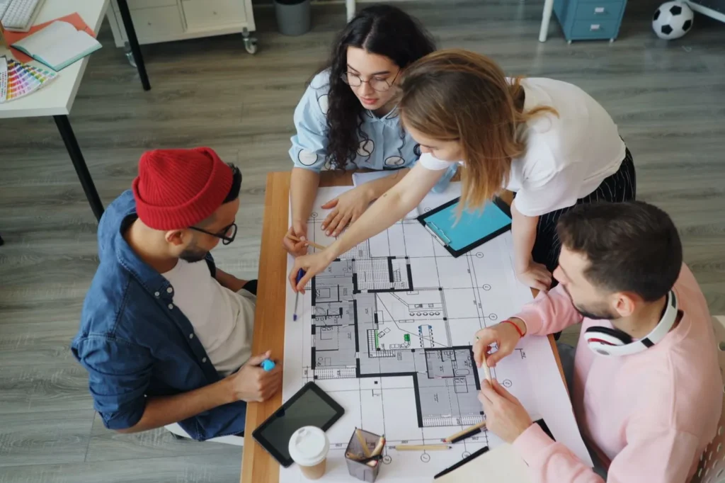 Team reviewing a floor plan and test-fit on the table