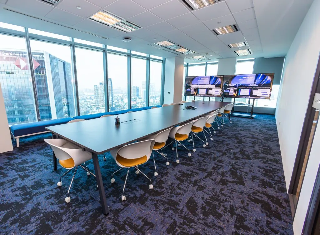 Long boardroom with a video wall, ready for handover