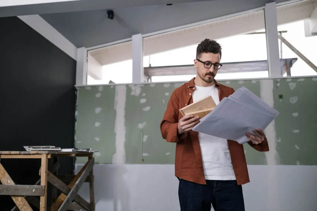 A project lead checking the drawings on site during an office design and build